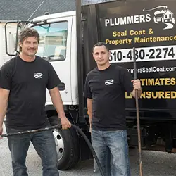 picture of two guys with crack filling equipment and a work truck